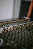 An audio mixer with its knobs and sliders meticulously adjusted, embodying precision and control in the art of sound engineering and music production photo