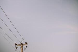 A lone utility pole against a clear sky, offering ample space for text or graphics, perfect for conveying messages or advertisements photo