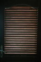 A wooden door featuring linear vents, blending functionality and rustic charm, perfect for enhancing ventilation and aesthetic appeal in any space. photo