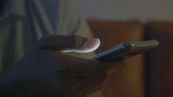 Close up of man's hand using smart phone at night video