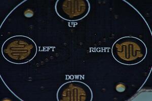 a close up of a circuit board with gold and silver circles photo