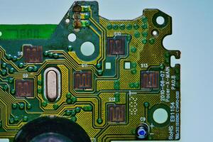 a close up of a green electronic circuit board photo