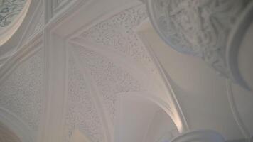 Bottom view of decorative walls and columns details. Scene. Beautiful ornament on carved white walls, concept of architecture. video