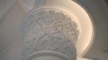 Inside the palace.Scene.A bright white stone column that is located on a white background of the palace and a high ceiling is also visible from white stone. video