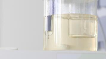 Close up of bubbling liquid substance inside flask at the laboratory. Action. Concept of science and chemistry. video