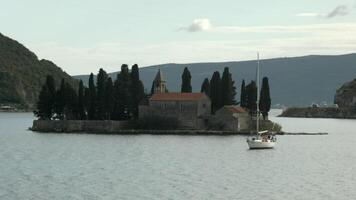 Montenegro, Perast - July 29, 2021. Top view of island with medieval fortress. Creative. Beautiful landscape of island in middle of bay with medieval architecture. St. George Island is historical video