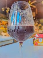 Red wine pouring in wineglass from bottle. Wine list design menu with copyspace photo