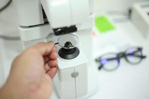Hand holding eyeglasses in optical store photo