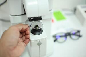Hand holding eyeglasses in optical store photo