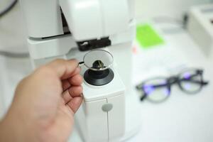 Hand holding eyeglasses in optical store photo