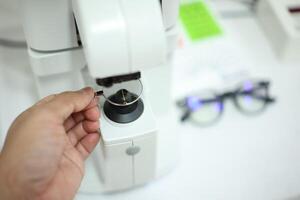 Hand holding eyeglasses in optical store photo