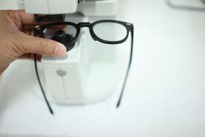 Hand holding eyeglasses in optical store photo
