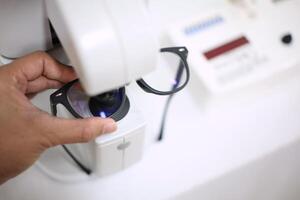 Hand holding eyeglasses in optical store photo