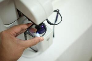 Hand holding eyeglasses in optical store photo