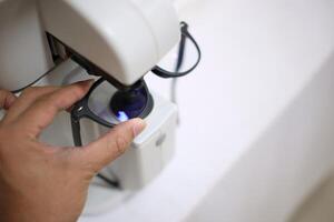 Hand holding eyeglasses in optical store photo