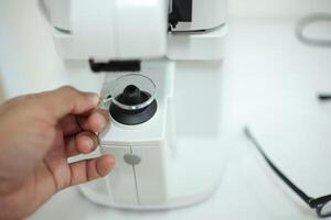 Hand holding eyeglasses in optical store photo