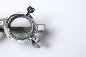 Trial frame glasses for eye test on chart in optical store photo
