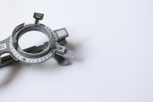 Trial frame glasses for eye test on chart in optical store photo