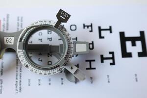 Trial frame glasses for eye test on chart in optical store photo