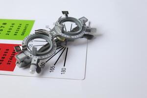 Trial frame glasses for eye test on chart in optical store photo