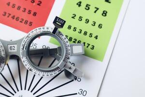 Trial frame glasses for eye test on chart in optical store photo