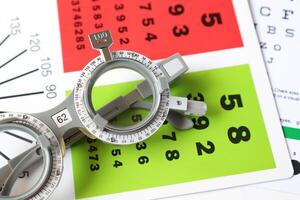 Trial frame glasses for eye test on chart in optical store photo