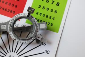 Trial frame glasses for eye test on chart in optical store photo