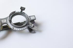 Trial frame glasses for eye test on chart in optical store photo