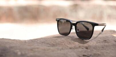 Sunglasses on the beach in summer photo