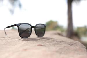 Sunglasses on the beach in summer photo