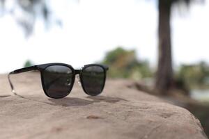 Sunglasses on the beach in summer photo
