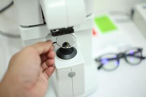 Hand holding eyeglasses in optical store photo