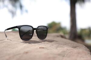 Sunglasses on the beach in summer photo