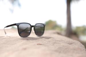 Sunglasses on the beach in summer photo