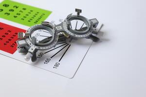 Trial frame glasses for eye test on chart in optical store photo