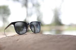 Sunglasses on the beach in summer photo