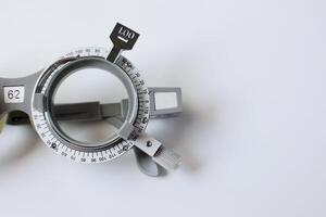Trial frame glasses for eye test on chart in optical store photo