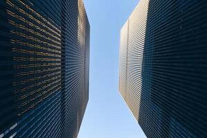 Bottom up view of modern skyscrapers with a blue sky on the background photo