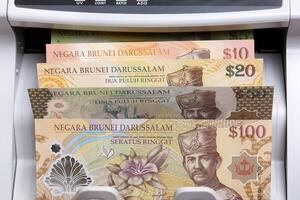 Brunei dollar in a counting machine photo