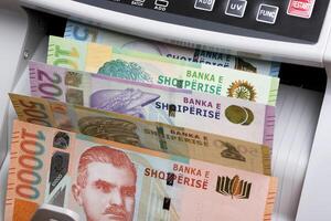 Albanian lek in a counting machine photo