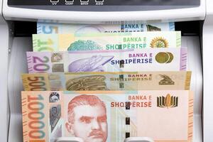 Albanian lek in a counting machine photo