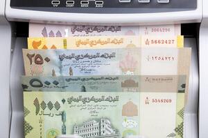 Yemeni rial in a counting machine photo