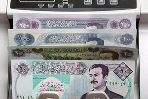 Old Iraqi Dinar in a counting machine photo