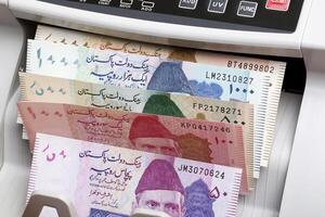 Pakistani rupee in a counting machine photo