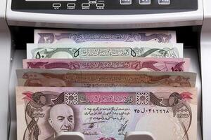 Old Afghan Afghani in a counting machine photo