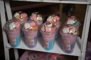 a shelf with several cups filled with marshmallows photo