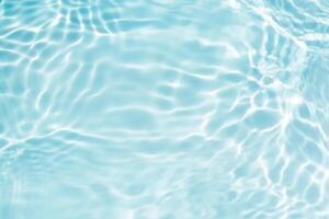 Bluewater waves on the surface ripples blurred. Defocus blurred transparent blue colored clear calm water surface texture with splash and bubbles. Water waves with shining pattern texture background. photo