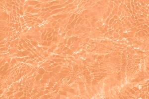 Blue water with ripples on the surface. Defocus blurred transparent blue colored clear calm water surface texture with splashes and bubbles. Water waves with shining pattern texture background. photo