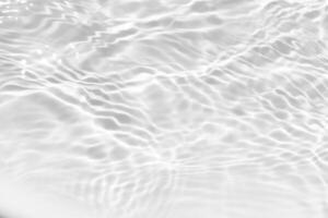 Blue water with ripples on the surface. Defocus blurred transparent blue colored clear calm water surface texture with splashes and bubbles. Water waves with shining pattern texture background. photo