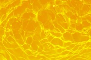 Blue water with ripples on the surface. Defocus blurred transparent blue colored clear calm water surface texture with splashes and bubbles. Water waves with shining pattern texture background. photo